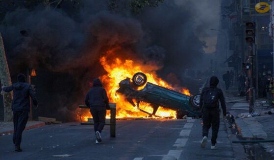 Rioters set cars on fire at the Canal Saint Martin during severe unrest on Oct. 17, 2026, in Paris, France.