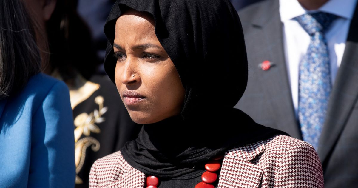 Rep. Ilhan Omar wears an anti-assault rifle pin during a news conference on gun violence, outside the U.S. Capitol in Washington, D.C., on March 29, 2023.