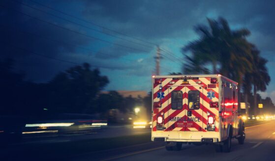 An ambulance driving in a Florida suburban area.