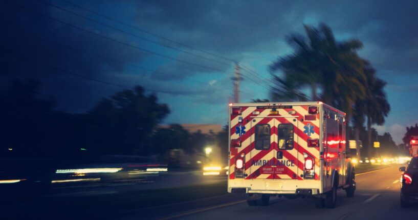 An ambulance driving in a Florida suburban area.