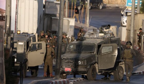 Israeli forces deploy at the scene following a fire exchange with two armed Palestinian men at the northern checkpoint of Hebron in the West Bank on Oct. 23, 2026.