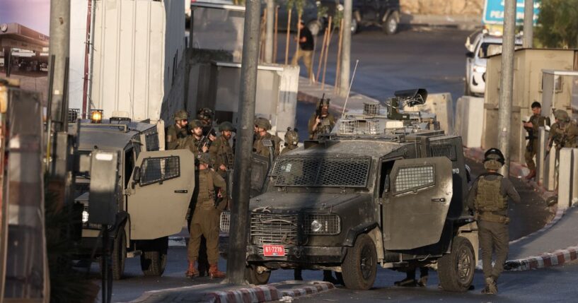 Israeli forces deploy at the scene following a fire exchange with two armed Palestinian men at the northern checkpoint of Hebron in the West Bank on Oct. 23, 2026.
