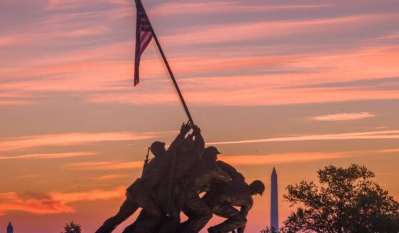 Sunrise turns the sky orange and red behind the U.S. Marine Corps War Memorial on Oct. 2, 2026, in Arlington, Virginia.