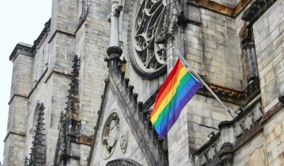 A "pride" flag flying on the facade of Cathedral Church of St. John the Divine in Morningside Heights, Manhattan, New York City.