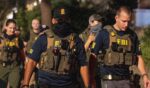 FBI agents walk down Florida Ave between 14th street NW and 13th street NW on Aug. 13, 2025, in Washington, D.C.