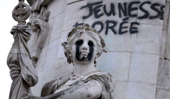 This photograph shows the "Egalite" statue with black tears and a graffiti reading "Golden Youth" in the "Monument a la Republique" at the Place de la Republique in Paris on Oct. 21, 2026.