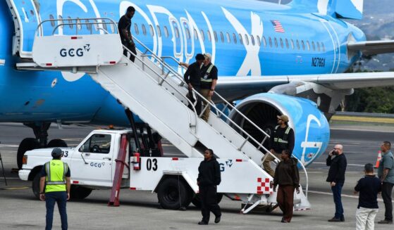 Migrants deported from the United States get off an airliner at the runway of the Juan Santamaria International Airport in Alajuela, Costa Rica, on April 11.
