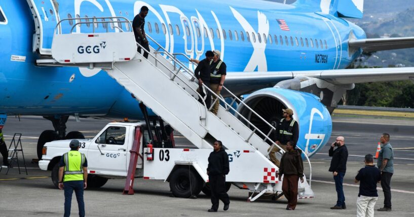 Migrants deported from the United States get off an airliner at the runway of the Juan Santamaria International Airport in Alajuela, Costa Rica, on April 11.