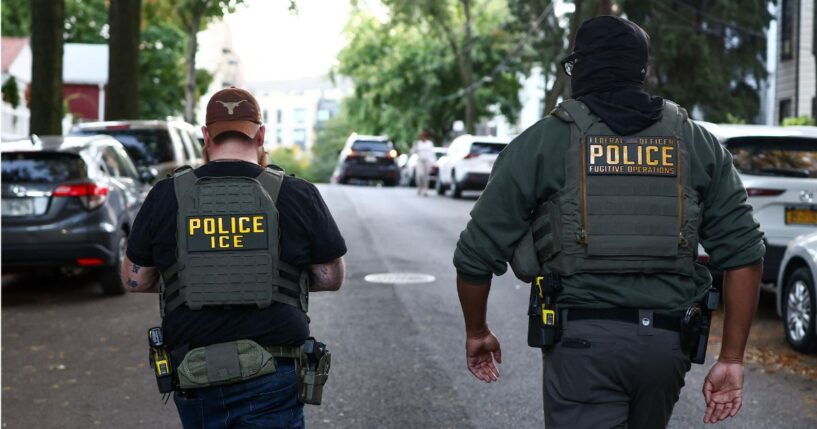 Federal agents are pictured at the scene of an immigration enforcement operation.