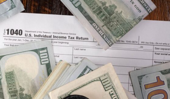 Money is pictured lying on a 1040 form.