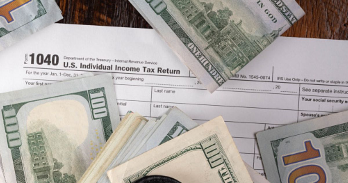Money is pictured lying on a 1040 form.