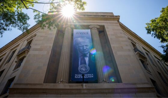 President Trump is displayed on a banner hanging between pillars at the Department of Justice headquarters in Washington, D.C. on May 18, 2026.