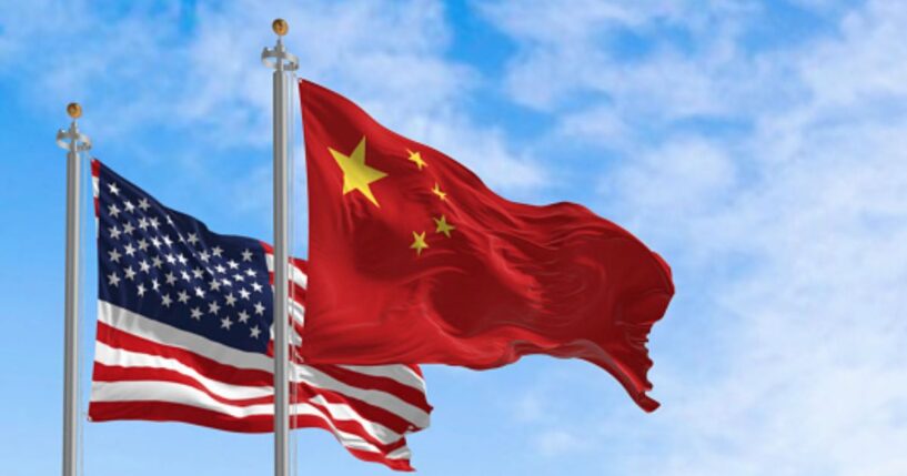 The Chinese flag flies next to an American flag.