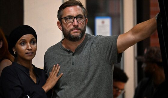 U.S. Rep. Ilhan Omar, a Minnesota Democrat, left, stands with her husband Tim Mynett at an August campaign rally in Milwaukee, Wisconsin.