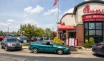 Cars roll through the drive-through of a Chick-fil-A restaurant.
