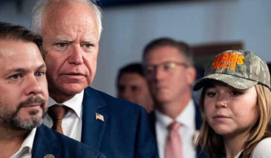 Vice Presidential candidate and Minnesota Governor Tim Walz stands with his daughter Hope Walz and DemocraticCongressman Ruben Gallego of Arizona in Phoenix, Arizona, on Aug. 9, 2024.