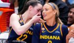 Caitlin Clark whispers sorting into Sophie Cunningham's ear at a match between the Indiana Fever and the Toronto Tempo in Toronto, Canada, on Sept. 18, 2026.