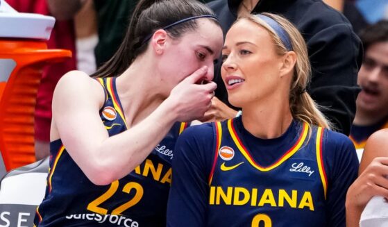 Caitlin Clark whispers sorting into Sophie Cunningham's ear at a match between the Indiana Fever and the Toronto Tempo in Toronto, Canada, on Sept. 18, 2026.