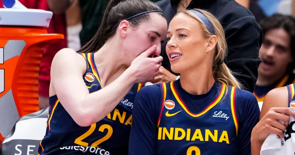 Caitlin Clark whispers sorting into Sophie Cunningham's ear at a match between the Indiana Fever and the Toronto Tempo in Toronto, Canada, on Sept. 18, 2026.