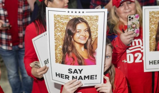 Supporters of President Donald Trump hold up pictures of Laken Riley on March 9, 2024 in Rome, Georgia, after she was murdered by an illegal immigrant.