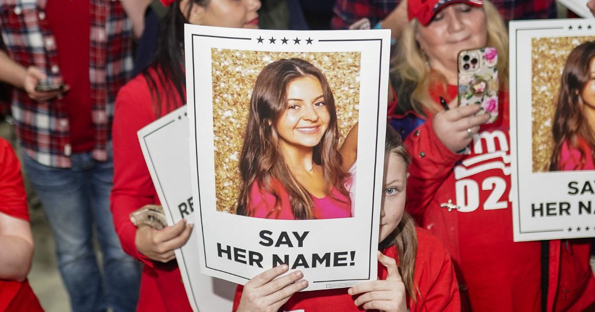 Supporters of President Donald Trump hold up pictures of Laken Riley on March 9, 2024 in Rome, Georgia, after she was murdered by an illegal immigrant.