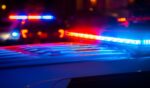 Red and blue police lights flash at a crime scene.
