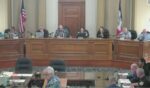 New Life Center pastor Rick Bick, foreground, in flowered shirt, urged the Ottumwa, Iowa, City Council to rebuke a satanic prayer offered moments earlier as an invocation offered by a member of the Satanic Temple of Iowa.