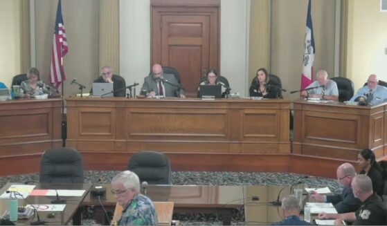 New Life Center pastor Rick Bick, foreground, in flowered shirt, urged the Ottumwa, Iowa, City Council to rebuke a satanic prayer offered moments earlier as an invocation offered by a member of the Satanic Temple of Iowa.