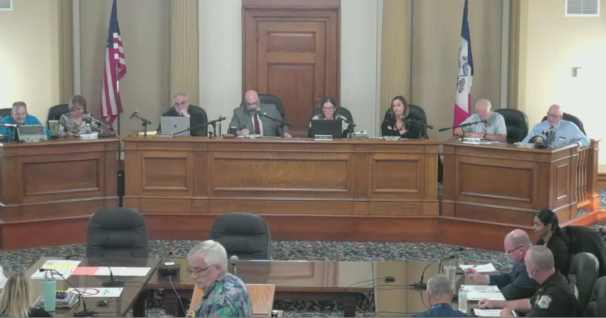 New Life Center pastor Rick Bick, foreground, in flowered shirt, urged the Ottumwa, Iowa, City Council to rebuke a satanic prayer offered moments earlier as an invocation offered by a member of the Satanic Temple of Iowa.