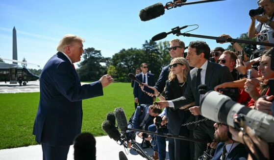 President Donald Trump talks to members of the media before boarding Marine One from the South Lawn of the White House in Washington, D.C., on Oct. 1.