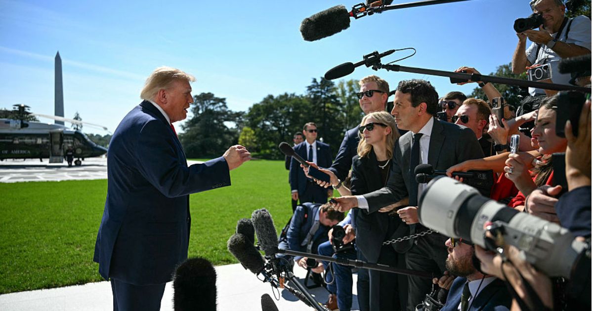 President Donald Trump talks to members of the media before boarding Marine One from the South Lawn of the White House in Washington, D.C., on Oct. 1.