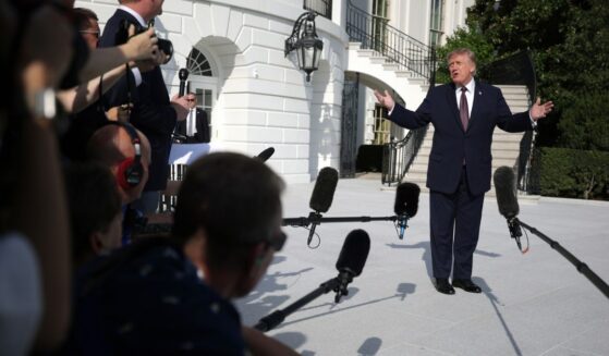 President Donald Trump speaks to members of the media before a South Lawn departure at the White House on Oct. 2.