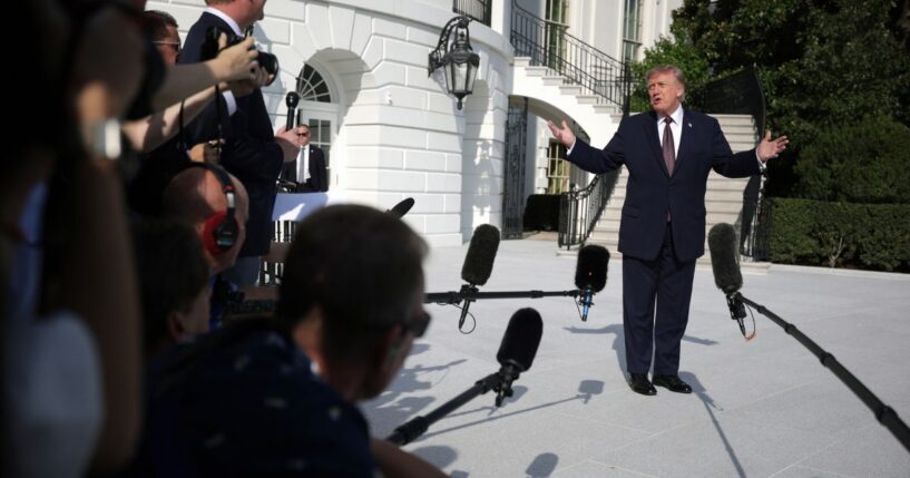 President Donald Trump speaks to members of the media before a South Lawn departure at the White House on Oct. 2.