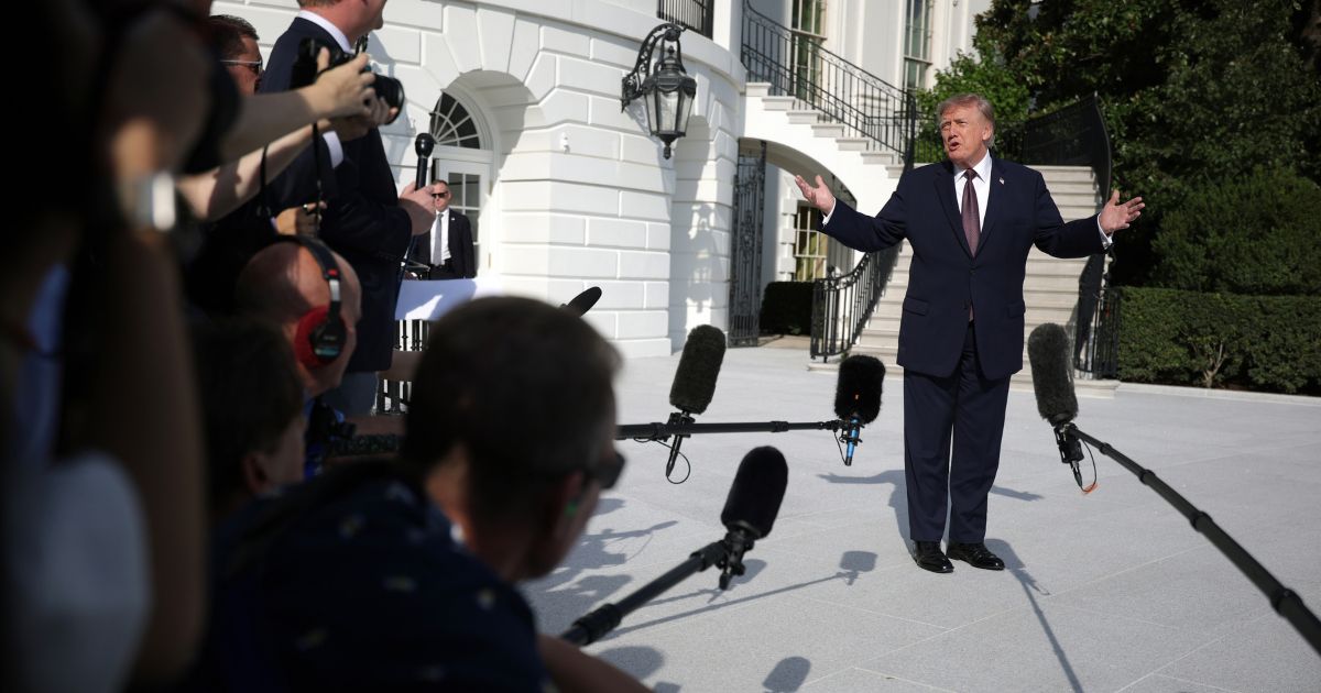 President Donald Trump speaks to members of the media before a South Lawn departure at the White House on Oct. 2.