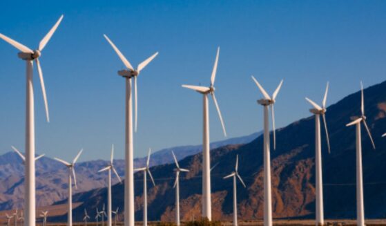 Wind turbines turn in a large field in Palm Springs, CA.
