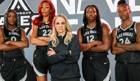Las Vegas Aces players, from left, Jackie Young, A'ja Wilson, Chelsea Gray and Jewell Lloyd stand behind coach Becky Harmon in a May publicity photo.