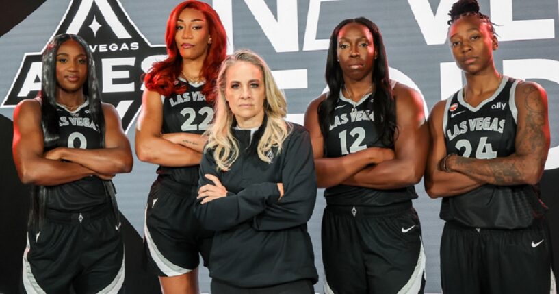 Las Vegas Aces players, from left, Jackie Young, A'ja Wilson, Chelsea Gray and Jewell Lloyd stand behind coach Becky Harmon in a May publicity photo.