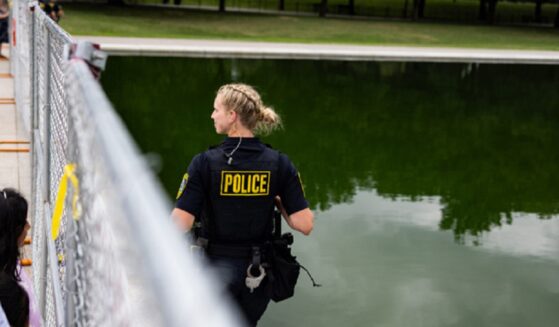 Police patrol the Lincoln Memorial Reflecting Pool in a June file photo during a controversy over vandalism at the pool aimed at embarrassing President Donald Trump.