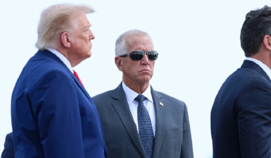 President Donald Trump and Sen. Thom Tillis are pictured in a July file photo from a ceremony marking the return of slain U.S. soldiers to American soil.