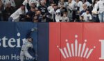 Victor Mesa Jr. of the Tampa Bay Rays hits the left field wall while trying to make a catch Wednesday during the sixth inning in Game Three of the American League Division Series at Yankee Stadium.