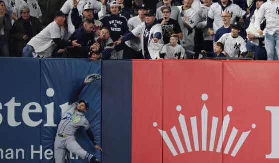 Victor Mesa Jr. of the Tampa Bay Rays hits the left field wall while trying to make a catch Wednesday during the sixth inning in Game Three of the American League Division Series at Yankee Stadium.