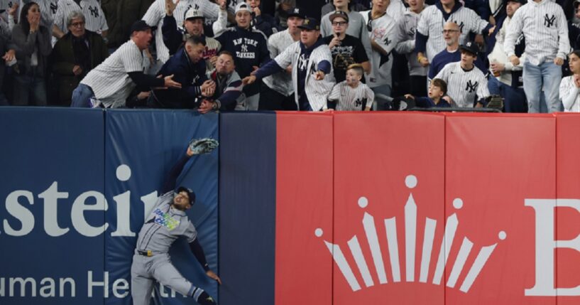 Victor Mesa Jr. of the Tampa Bay Rays hits the left field wall while trying to make a catch Wednesday during the sixth inning in Game Three of the American League Division Series at Yankee Stadium.